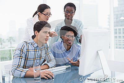 Casual business team working together at desk