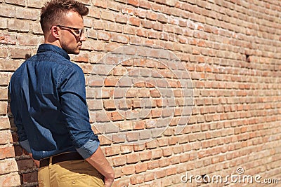 Casual man by wall back view