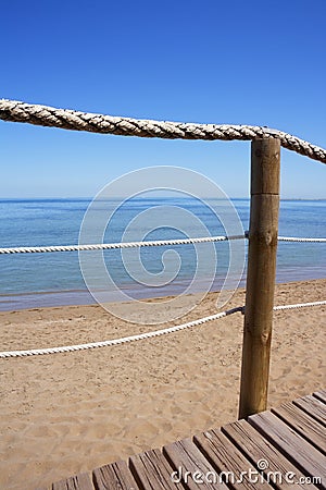 Catwalk on wood rope railing on sea beach