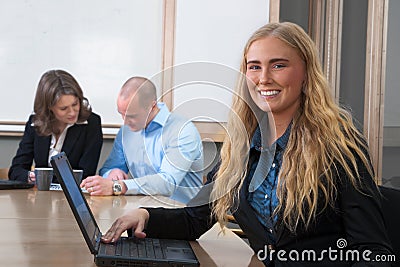 Caucasian businesswoman smiling at meeting