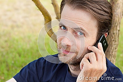 Caucasian man talking on a mobile phone outdoor