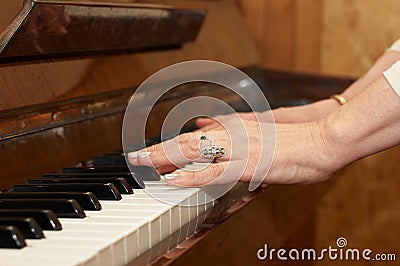 A caucasian woman s hand playing piano