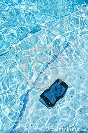 A Cell Phone Laying on the Steps of a Pool Underwater.