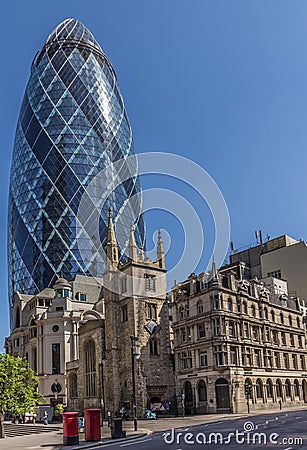 CENTRAL LONDON / ENGLAND - 18.05.2014 - The Gherkin sky-scraper is seen behind the St. Andrew Undercroft medieval church in London