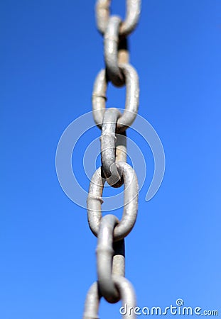 Chain links on blue sky background