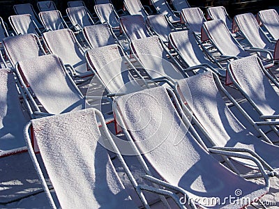 Chairs covered with snow