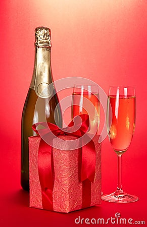 Champagne bottle, two wine glasses and gift box