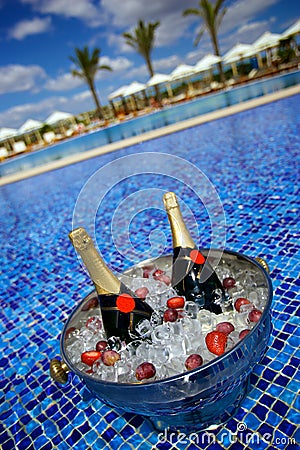 Champagne bottles on ice in a swimming pool