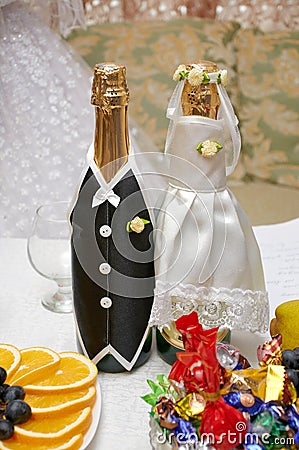 Champagne bottles in wedding clothes