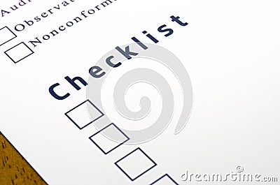Checklist with a ticked box on white paper.