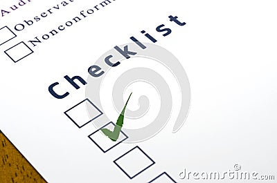 Checklist with a ticked box on white paper.
