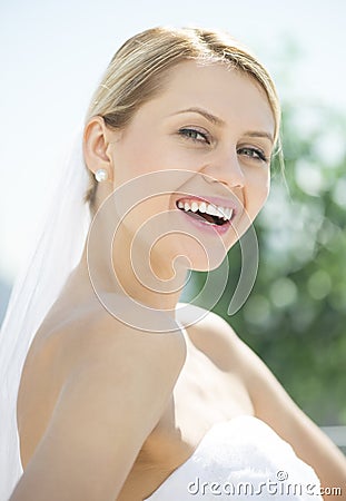 Cheerful Bride In Off Shoulder Wedding Dress Outdoors