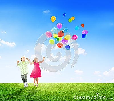 Cheerful Children Playing Balloons Outdoors