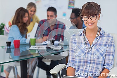 Cheerful designer holding a tablet pc