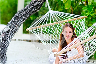 Cheerful girl relaxing in hammock