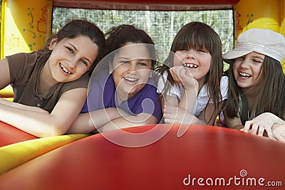 Cheerful Girls Lying In Bouncy Castle
