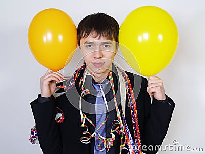 Cheerful man in a business suit with balloons