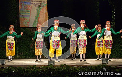 Cheerful Turkish dancers in folk costumes on stage