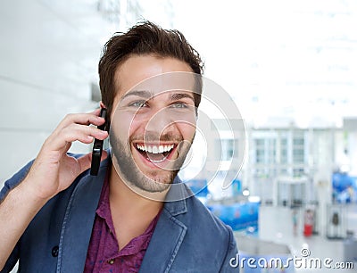 Cheerful young man talking on mobile phone