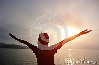 Cheering woman open arms on beach