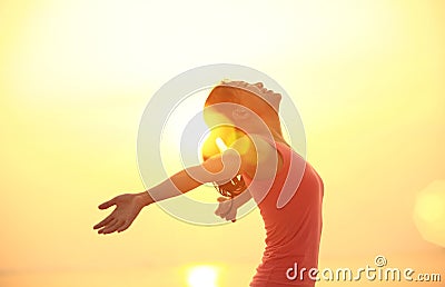 Cheering woman open arms on beach