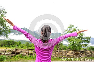 Cheering woman open arms in tibet