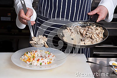 Chef add meat to risotto