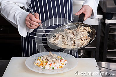 Chef add meat to risotto