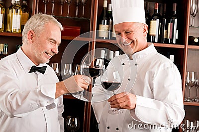 Chef cook and waiter wine tasting restaurant