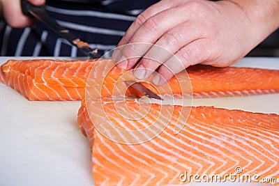 Chef cutting salmon fish