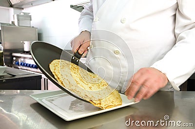 Chef hands serving pancake