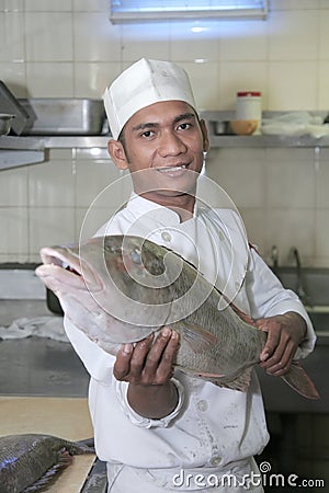 Chef holding fish at butcher