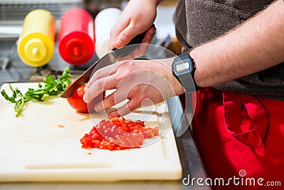 Chef making hotdog in fast food snack bar