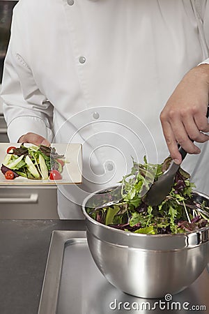 Chef Preparing Leaf Vegetables In Commercial Kitchen