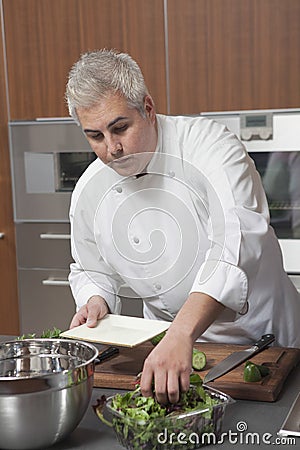 Chef Preparing Salad In Commercial Kitchen