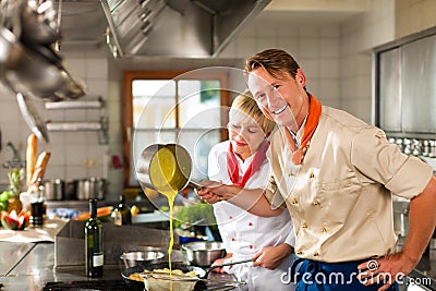 Chefs in a restaurant or hotel kitchen cooking