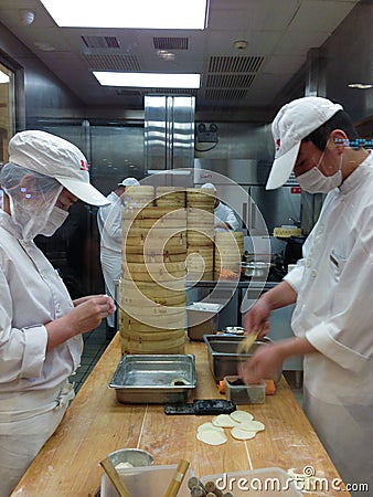 Chefs at work in a Chinese restaurant kitchen