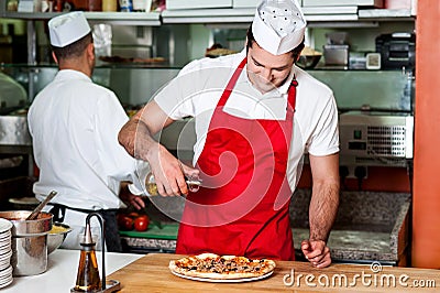 Chefs at work inside restaurant kitchen