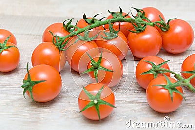 Cherry tomatoes on wooden background closeup