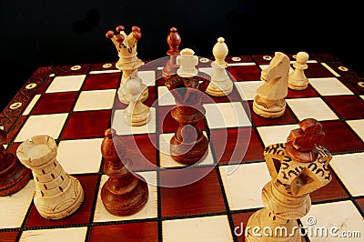 Chess pieces on chess board showing competition success and strategy 