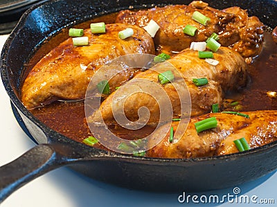 Chicken Breasts Cooking in a Cast Iron Pan