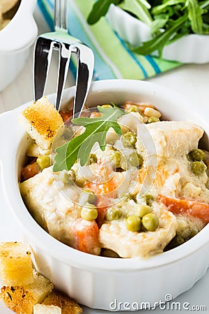 Chicken stew with carrot and green peas in a sauce