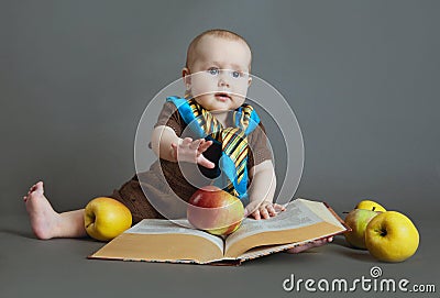 The child with the book and apples