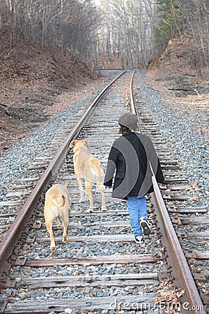 Child and dogs on train tracks