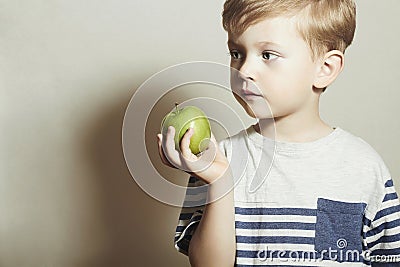 Child eating apple.Little Boy with green apple. Health food. Fruits. Enjoy Meal