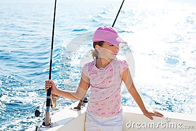 Child girl sailing in fishing boat holding rod