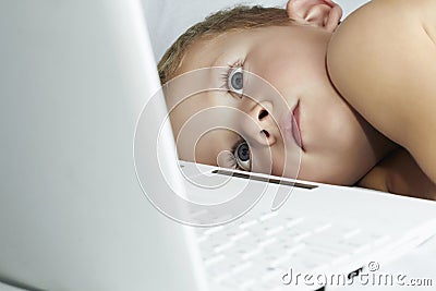 Child with laptop. 4 years old boy watching computer