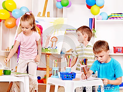 Child painting at easel.