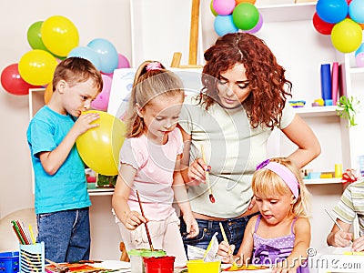 Child painting at easel.