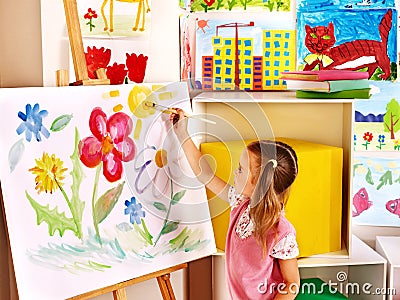 Child painting at easel.